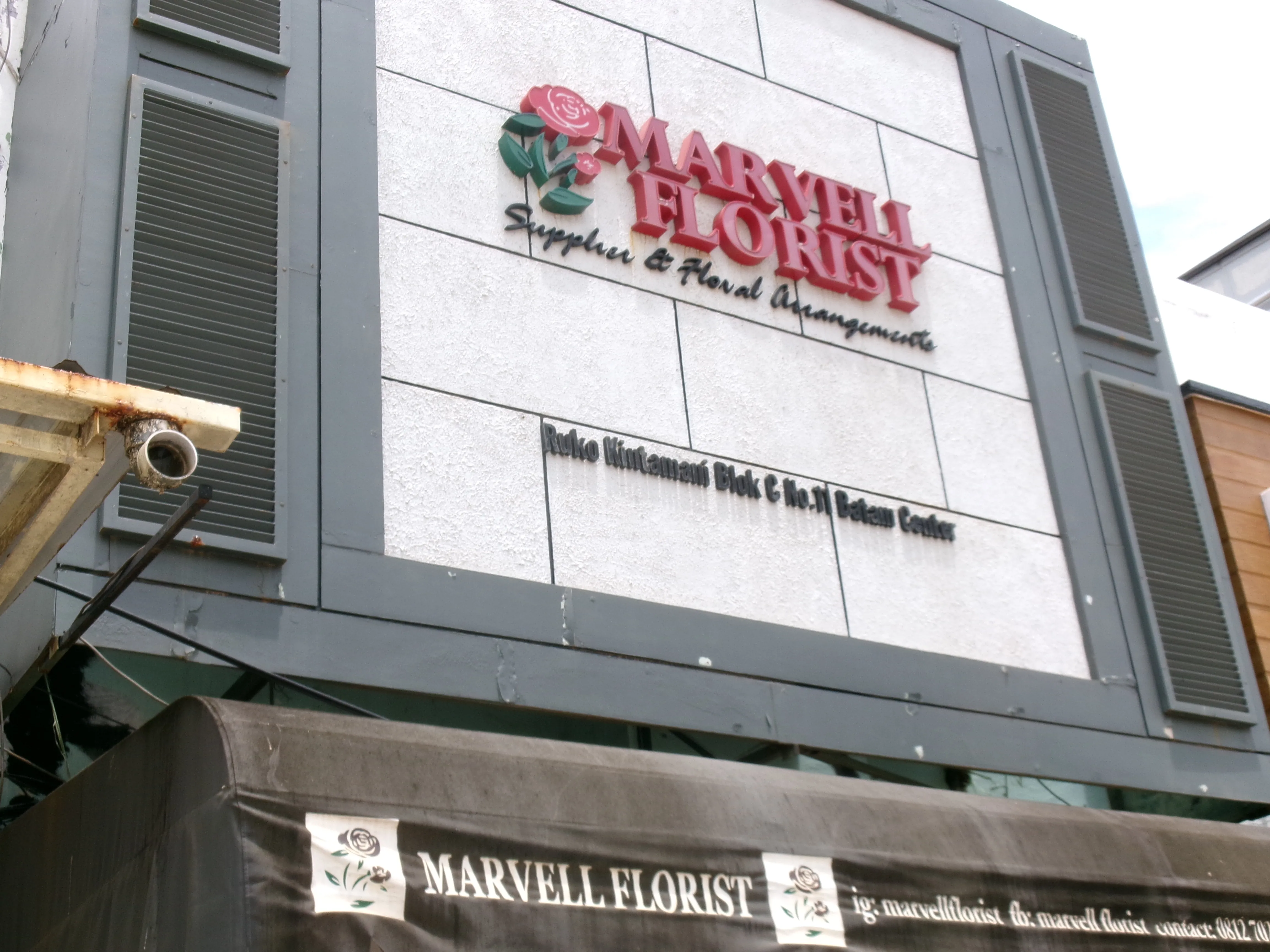 Storefront and floral display representing the journey of Marvell Florist